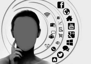 Image of woman's face with no facial features and to the right a series of concentric circles with different social media icons, digital icons and communication icons