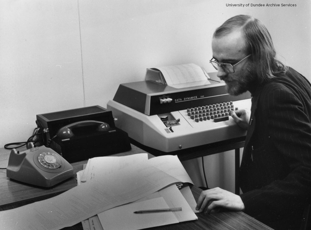 Man at computer in 70s
