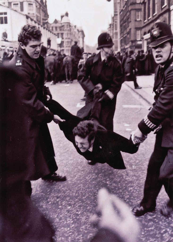 Policemen arresting a women