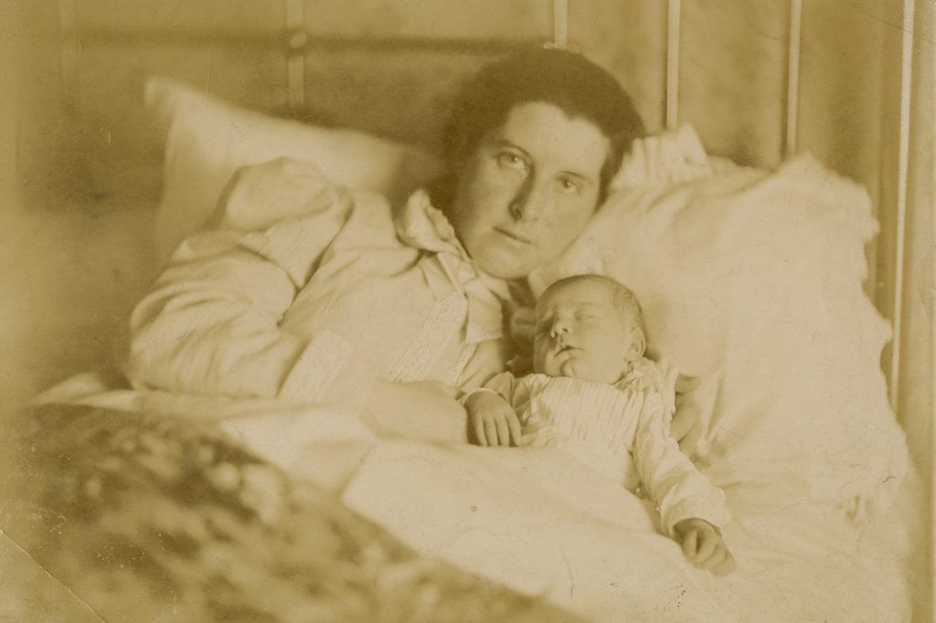 Woman and baby in bed
