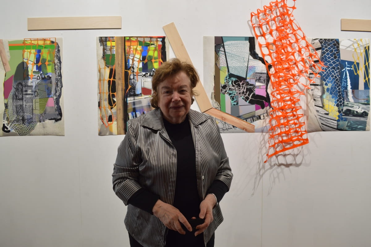 artist Ellen K Levy standing in front of the exhibition